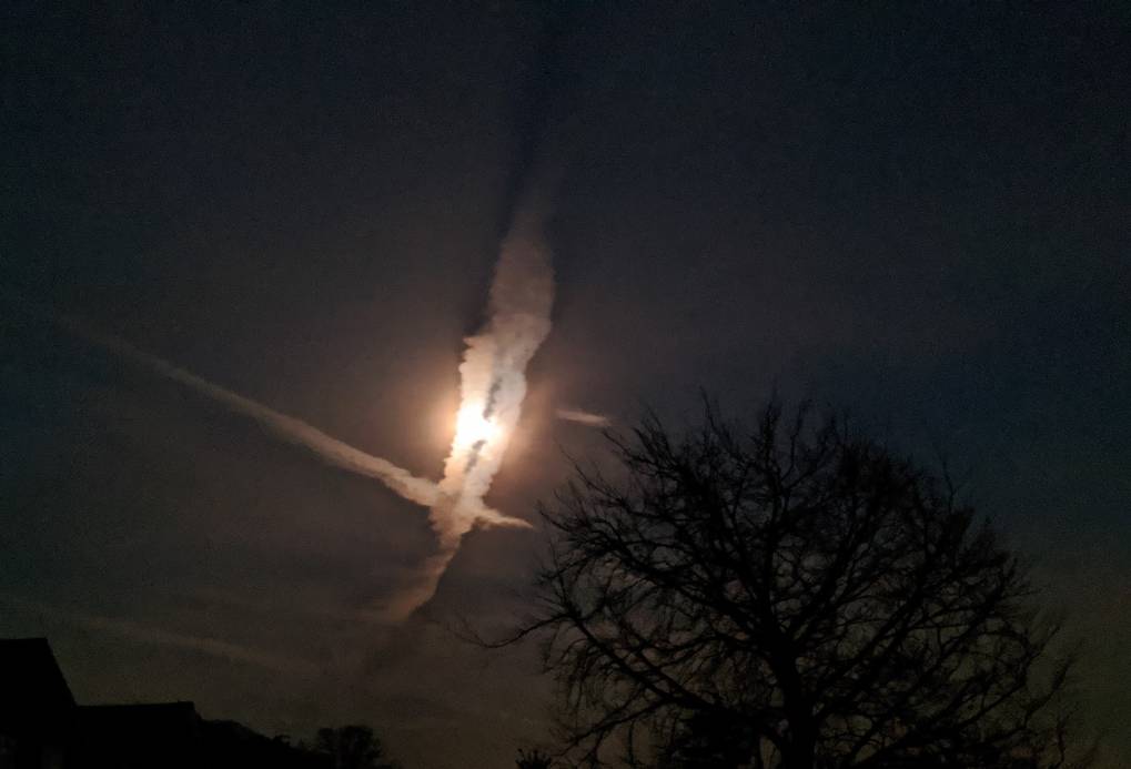 Berkhamsted, Hertfordshire, Crossing contrails covering the moon....