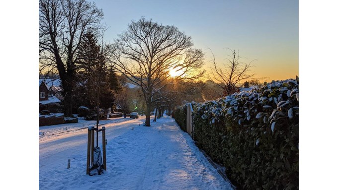 Iced up road and snow at sunrise. Posted by brian gaze