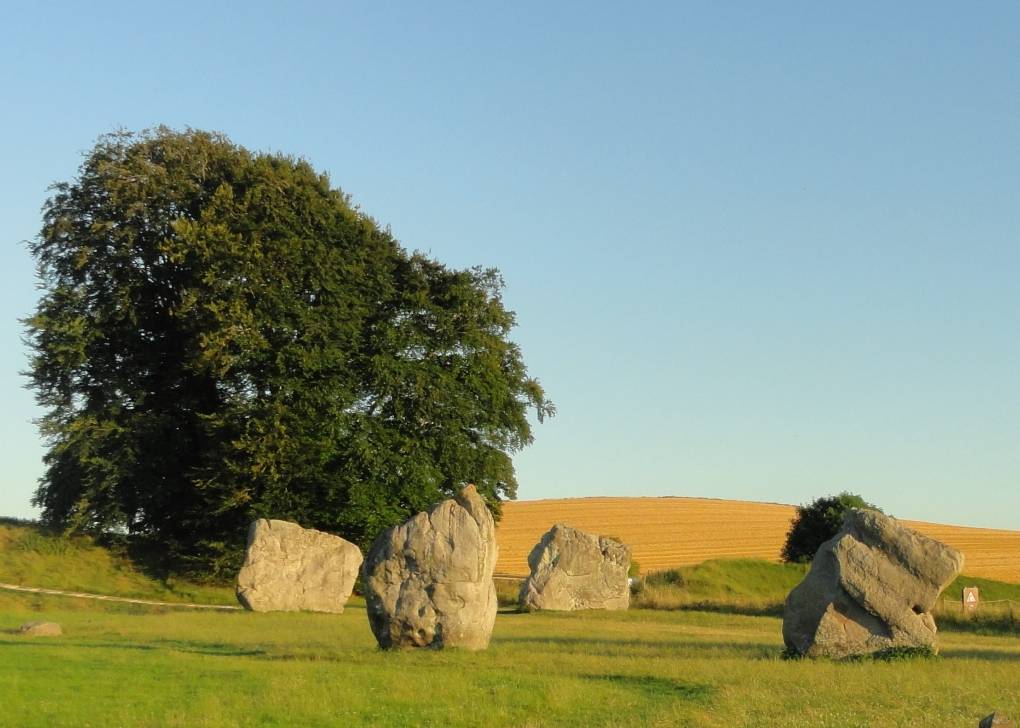 Avebury, Wilts, A small part of the stone circle on a fine evening, the bank, with ditch to...