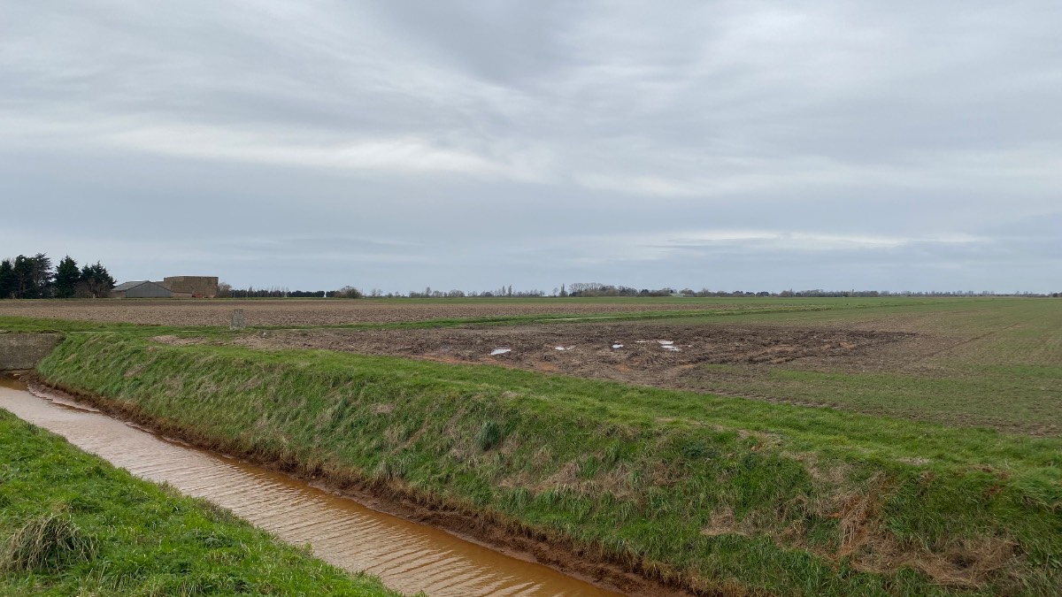 Gedney, Lincolnshire, Muddy fields and orange ditch water by the Wash...
