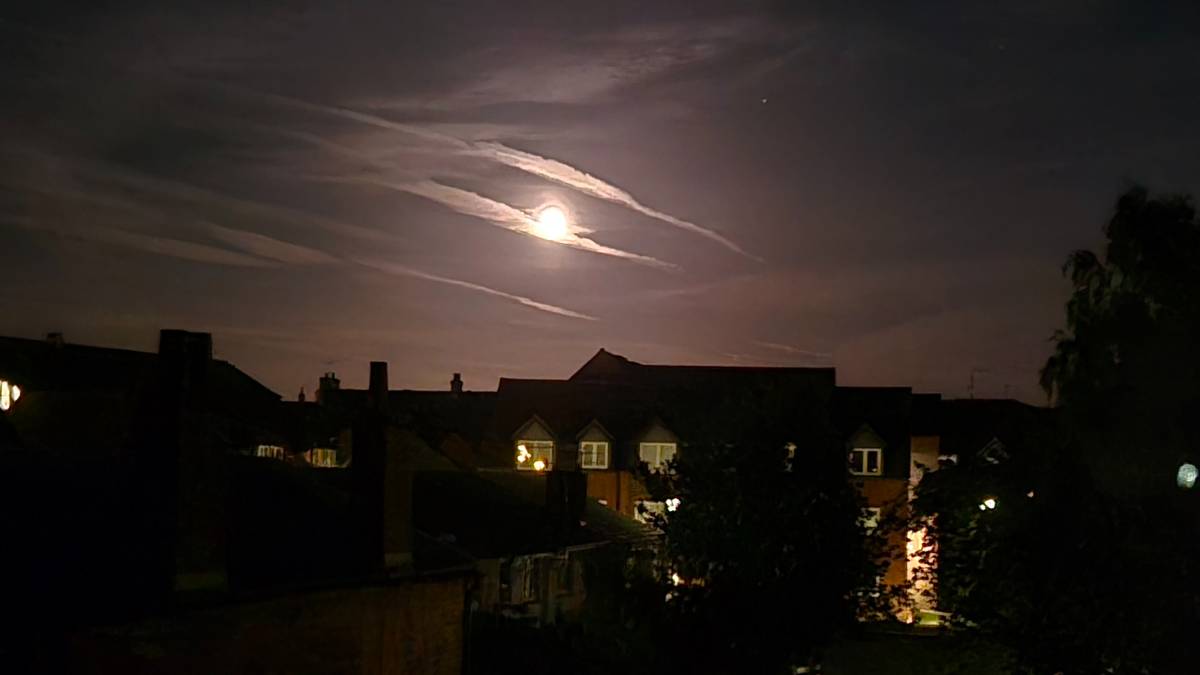 Chichester, West Sussex, The 'blue moon' - two full moons in a month of 31st May, seen over the roof...